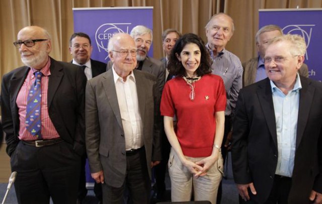British physicist Higgs poses with other scientists after a news conference update in the search for the Higgs boson at the CERN in Meyrin